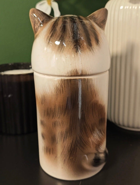 Rear view of a personalized tabby-and-white cat memorial urn with brown and dark tabby markings