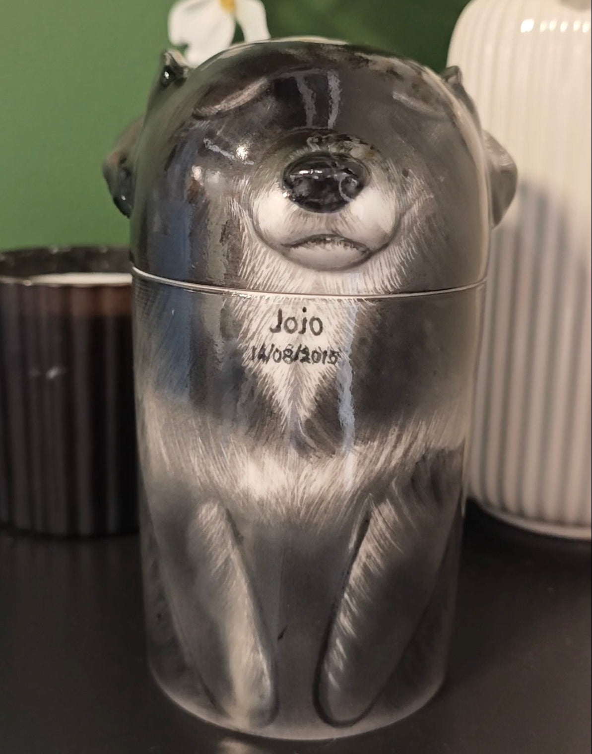 Personalized black dog ceramic urn for ashes with white muzzle and chest markings