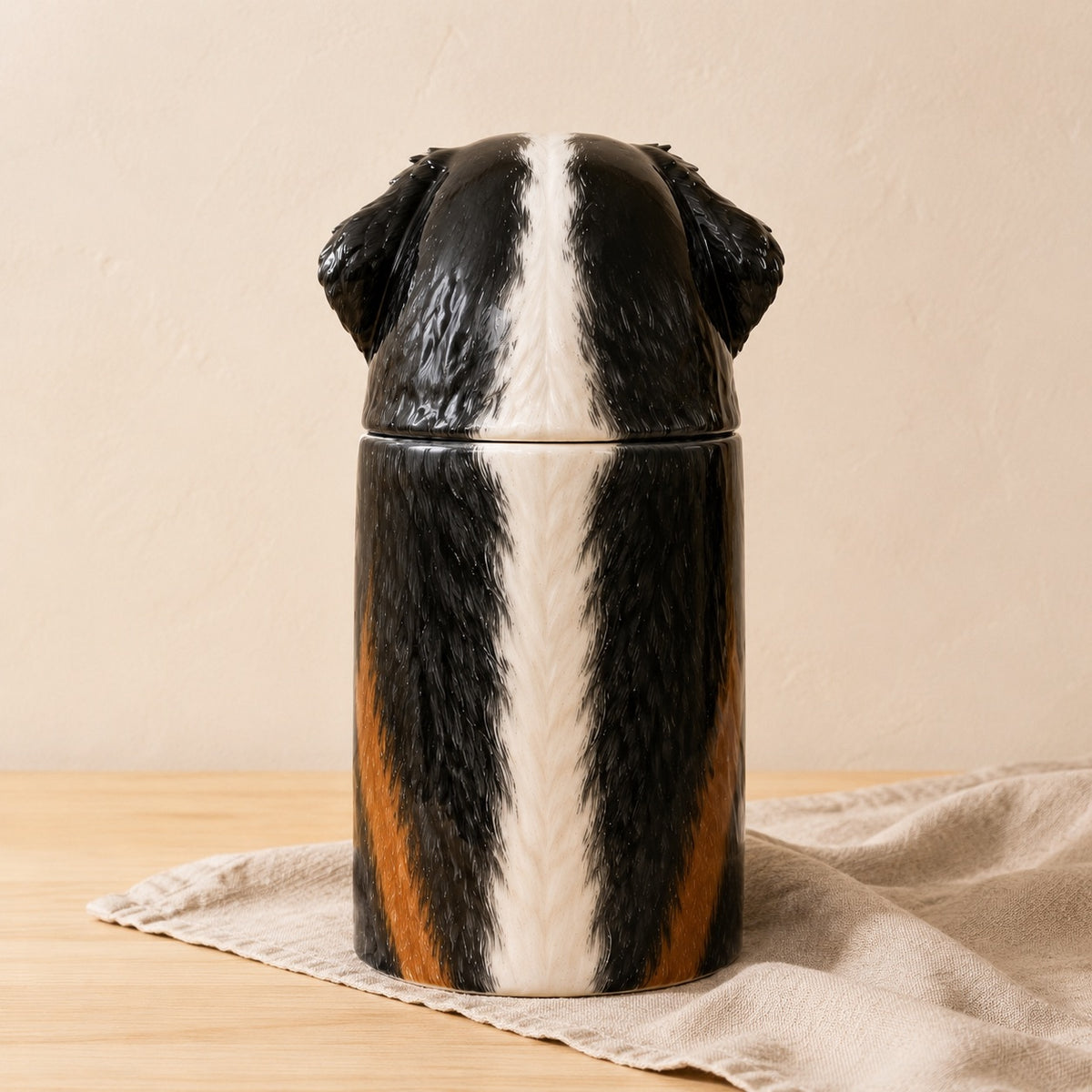 Rear view of a hand-painted ceramic Bernese Mountain Dog urn for ashes