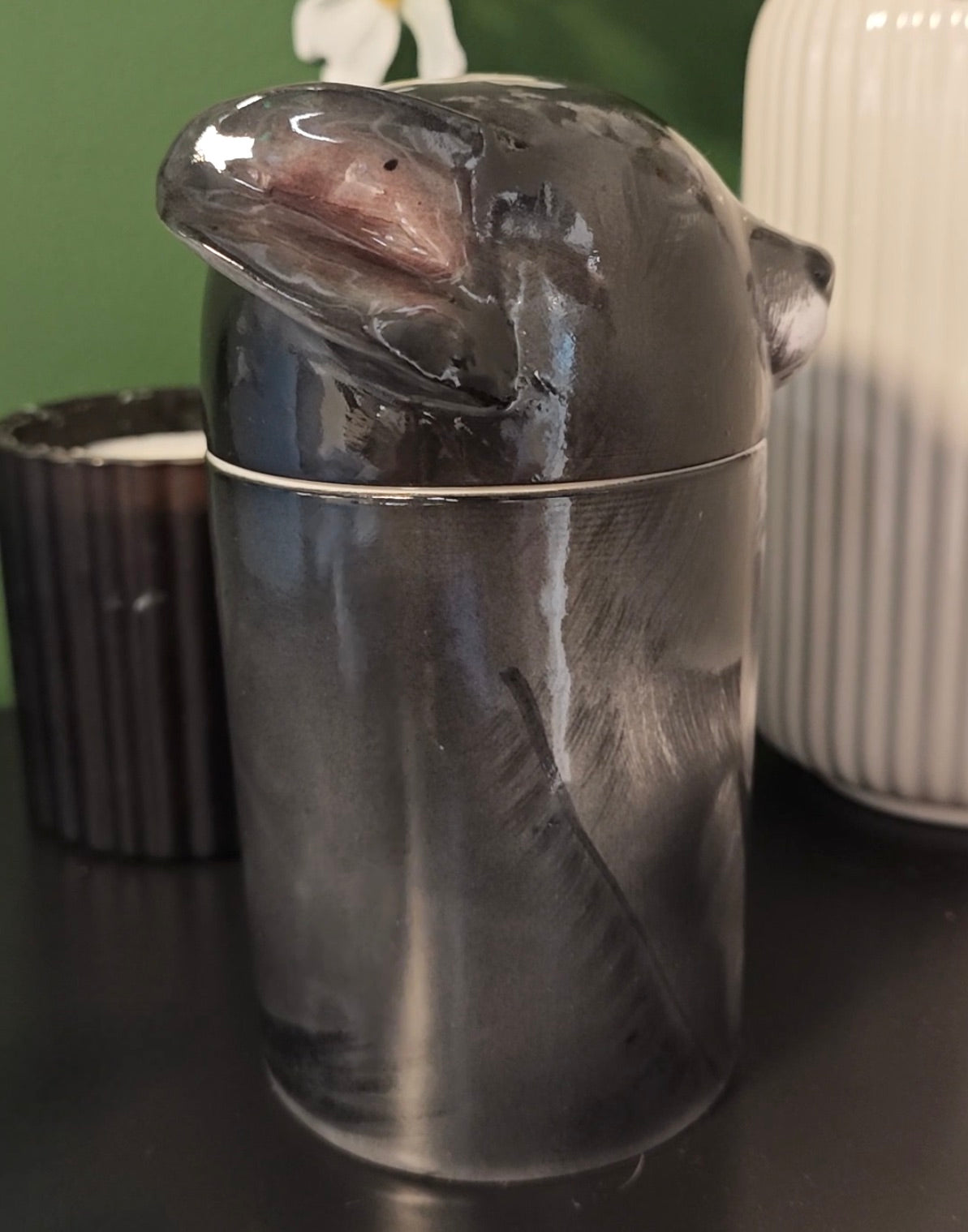 Right-side view of a personalized black dog ceramic urn showing its sculpted profile