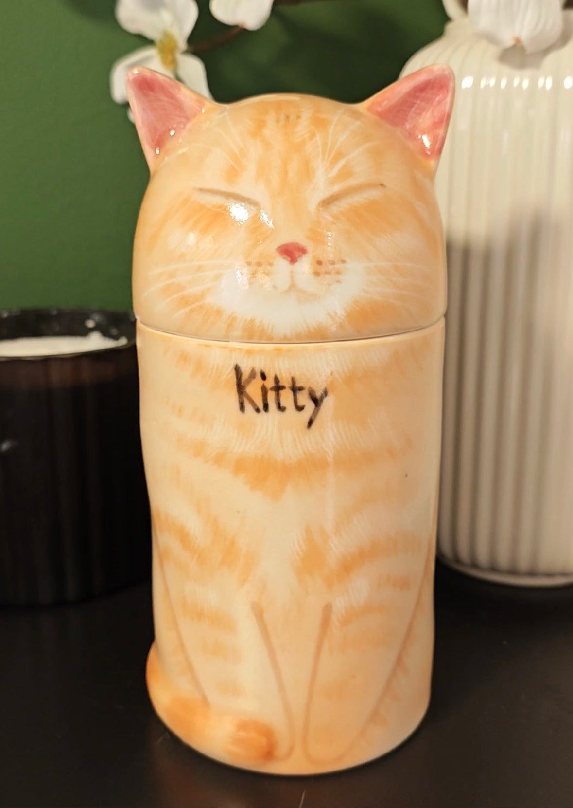 Personalized orange tabby cat urn for ashes with a hand-painted name