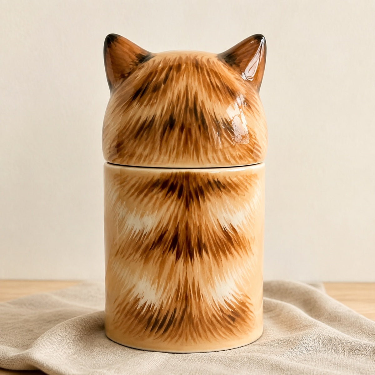 Rear view of a hand-painted ceramic tabby cat urn for ashes
