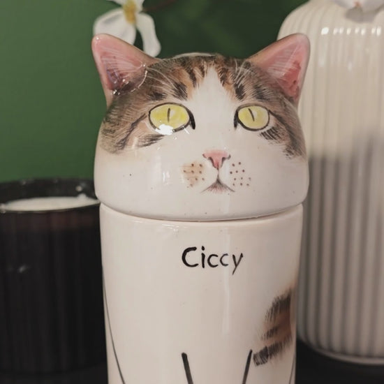 Small personalized tabby-and-white cat urn for ashes displayed as a hand-painted ceramic memorial