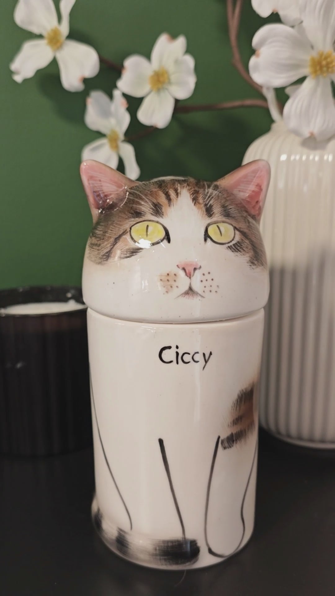 Small personalized tabby-and-white cat urn for ashes displayed as a hand-painted ceramic memorial